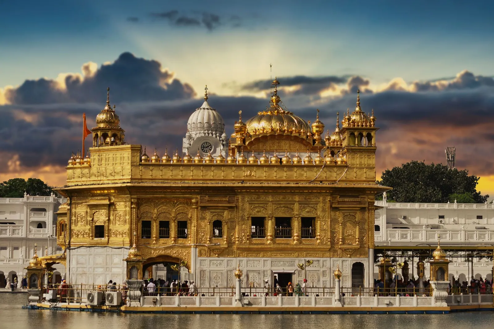 Stunning view of the Golden Temple in Amritsar, India, with a vibrant sunset sky.