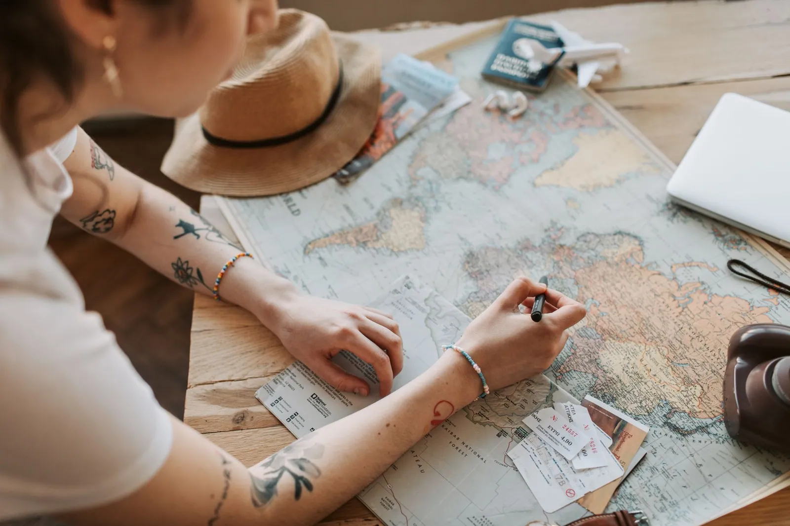 Traveller planning a journey with a map and passport